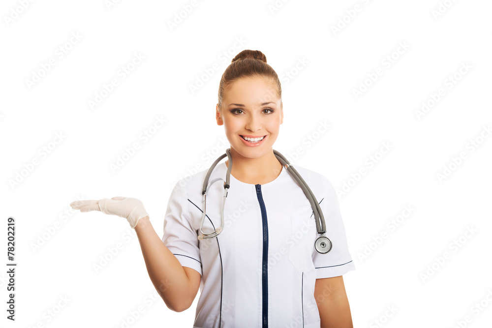 Female doctor presenting copyspace on the left Female doctor presenting copyspace on the left