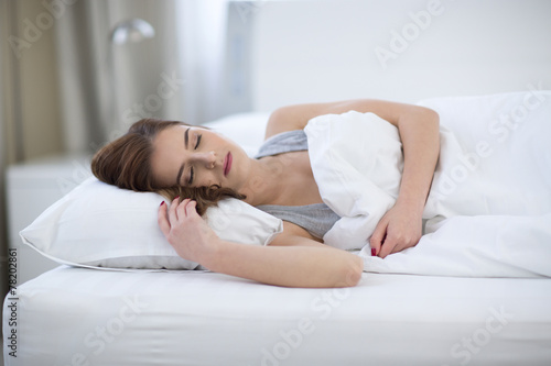 Beautiful woman sleeping on the bed at home