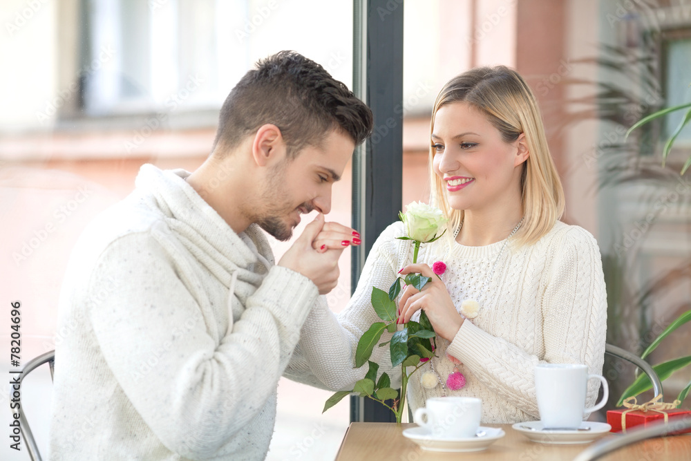 Romantic young man kissing hand of his girlfriend Romantic young man kissing hand of his girlfriend