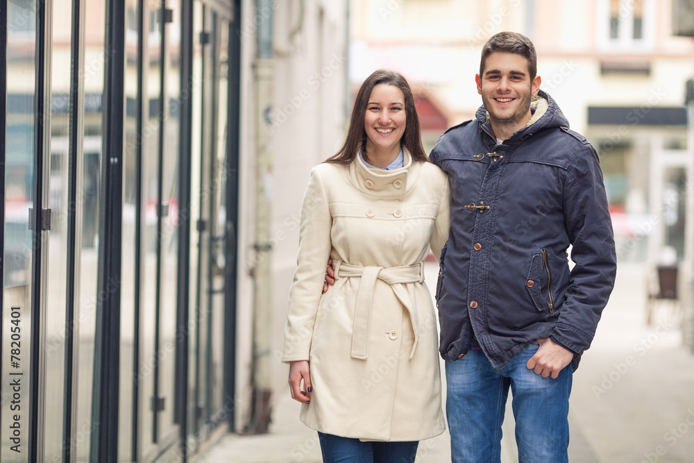 Cheerful young couple standing on the street