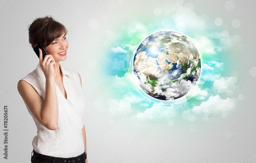 Fototapeta premium Young woman with earth and cloud concept