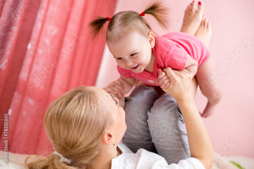 Young mother holding baby, fun, exercise, leisure