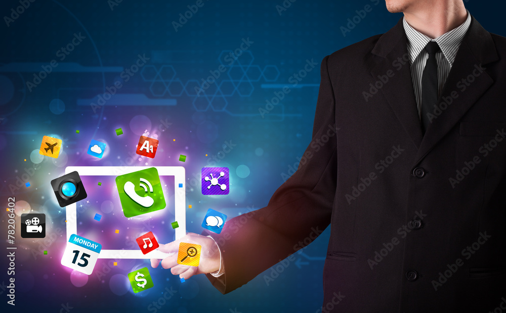 Businessman holding a tablet with modern colorful apps and icons Businessman holding a tablet with modern colorful apps and icons