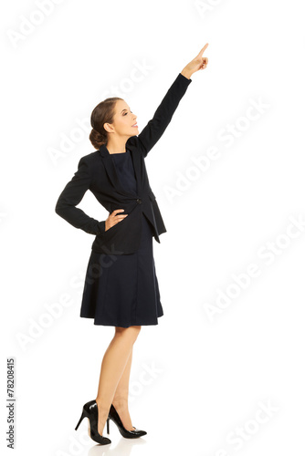 Pretty businesswoman pointing up