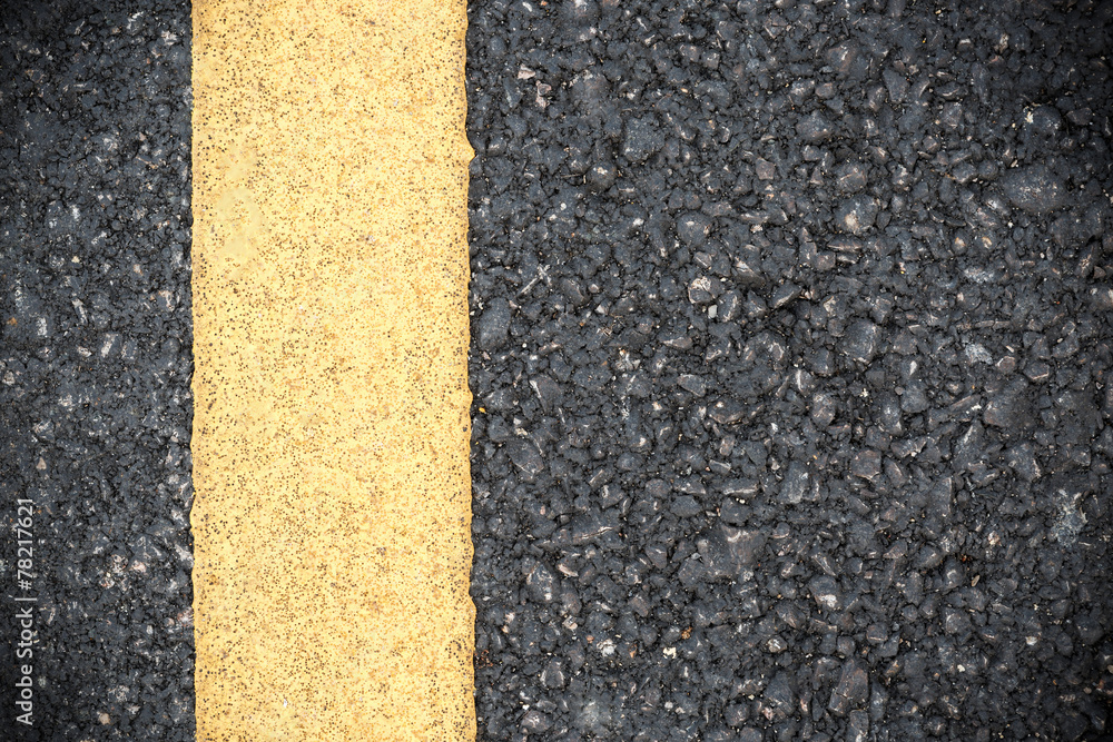 Fototapeta premium Yellow line on road texture
