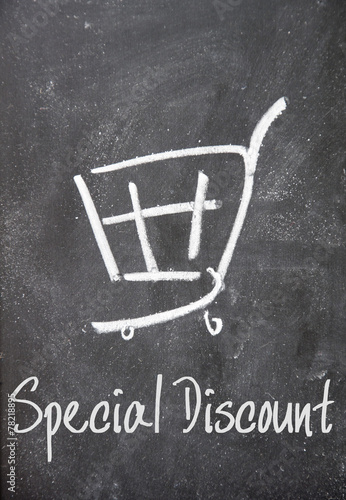 special discount text and shopping cart sign on blackboard