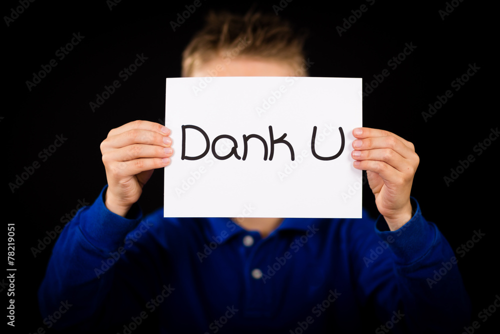 Child holding sign with Dutch words Dank U - Thank You Child holding sign with Dutch words Dank U - Thank You