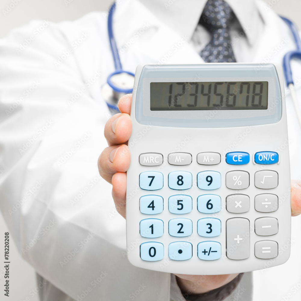 Medical doctor holding calculator - closeup shot Medical doctor holding calculator - closeup shot