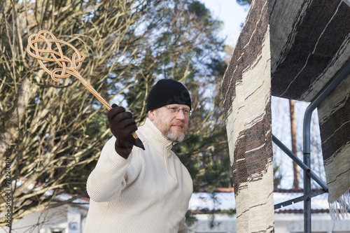 Man with a Carpet Beater photo