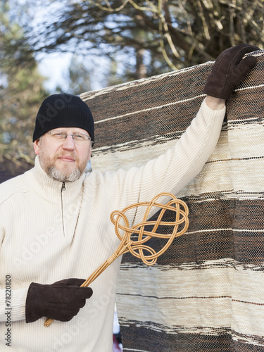 Man with a Carpet Beater photo