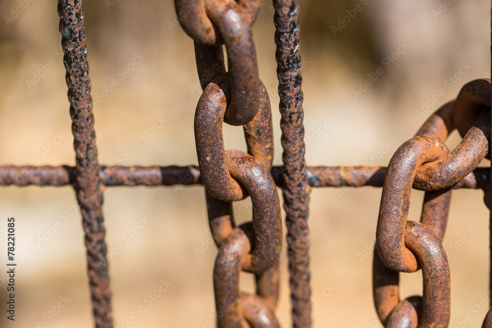 Rusty chain on an old metal fence Rusty chain on an old metal fence