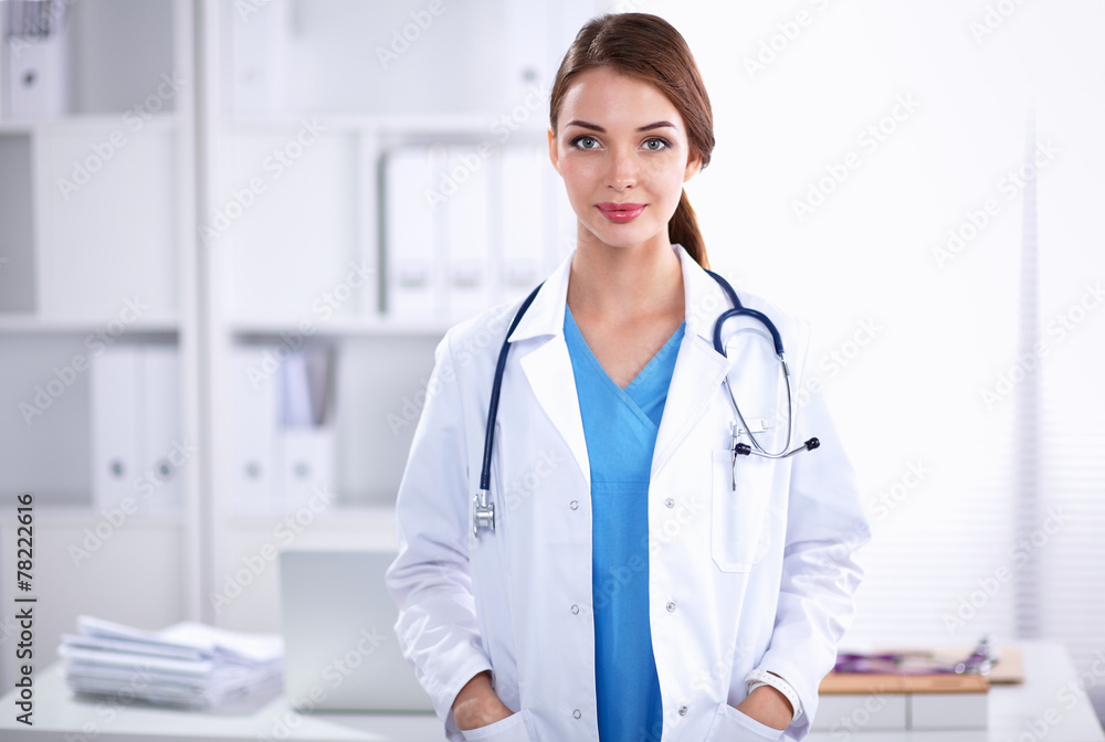 Portrait of young woman doctor with white coat standing in Portrait of young woman doctor with white coat standing in