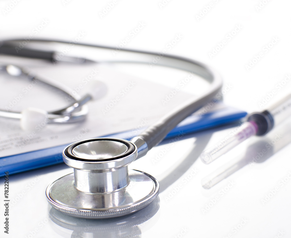 Medical history on clipboard with stethoscope on light backgroun Medical history on clipboard with stethoscope on light backgroun