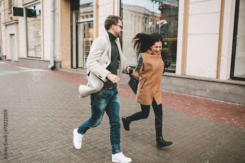 Young fashionable couple walks the city streets in winter