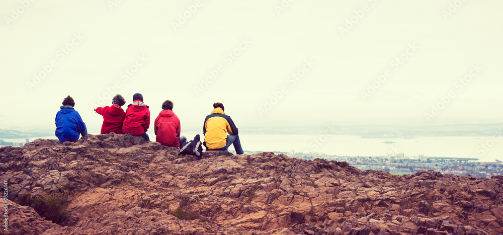 Family enjoying view of Edinburgh from top of Arthurs seat Family enjoying view of Edinburgh from top of Arthurs seat