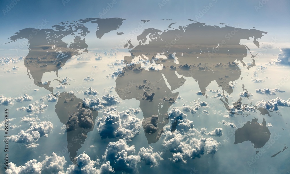 World map on the background of sky with clouds.