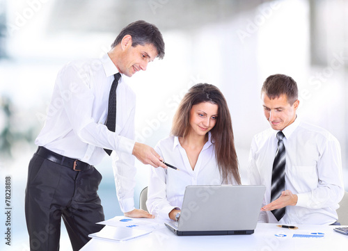 smiling female boss talking to business team