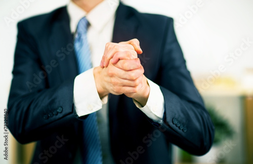 Businessman at the office with his hands folded. photo