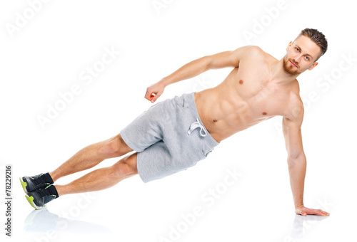 Sport attractive man doing fitness exercises on the white