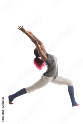 Woman practicing Warrior yoga pose