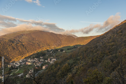 Sunrise on a small old town on mount Strega in Autumn, blue sky