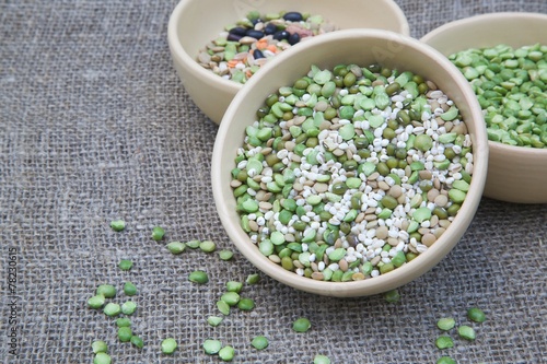 An assortment of legumes and cereals in a clay dish photo