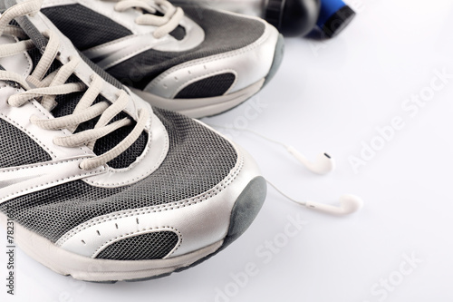 Sport shoes and headphones close up