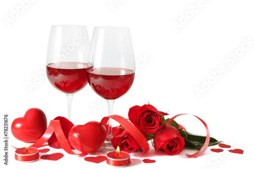 Composition with red wine in glasses, red roses, ribbon and