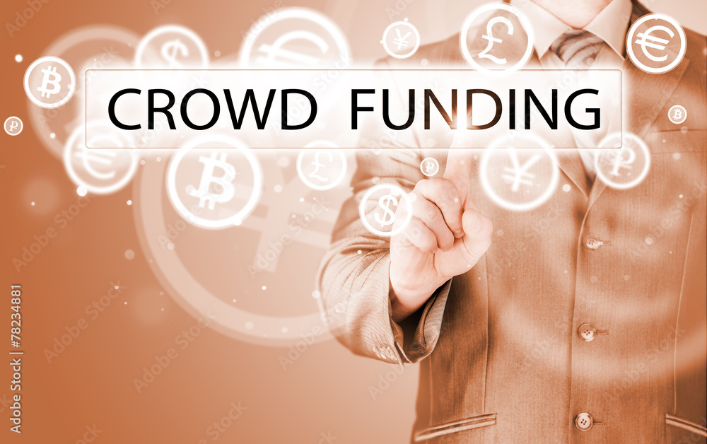 Businessman pushes virtual crowd funding button Businessman pushes virtual crowd funding button