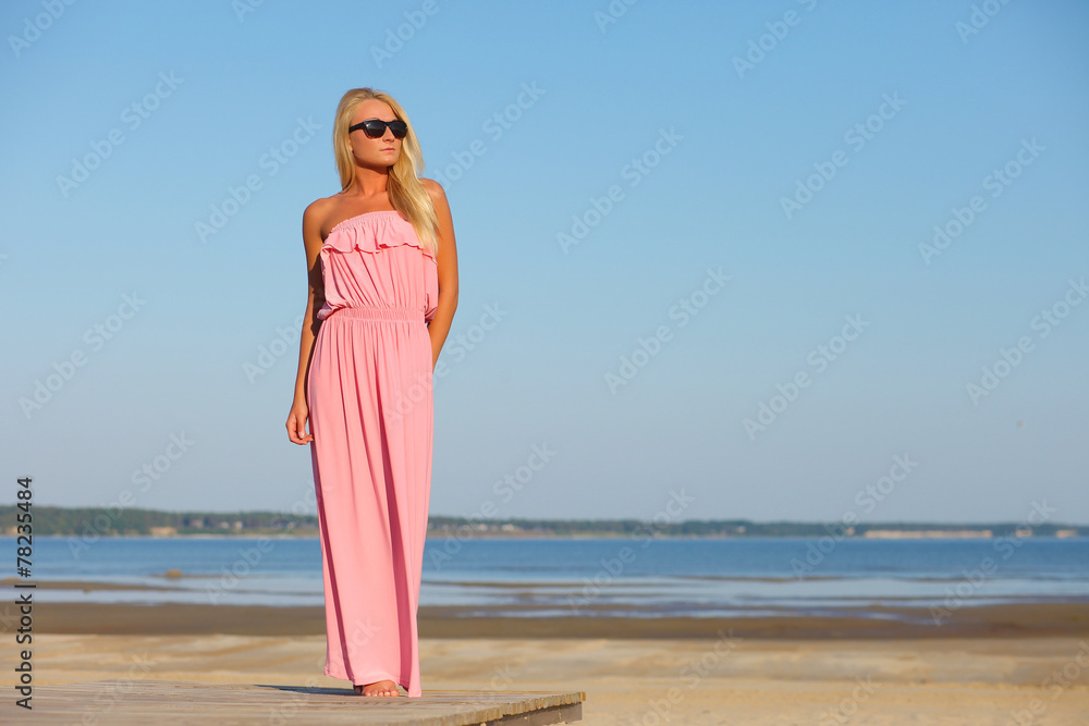 girl in dress and sunglasses on background of sky girl in dress and sunglasses on background of sky