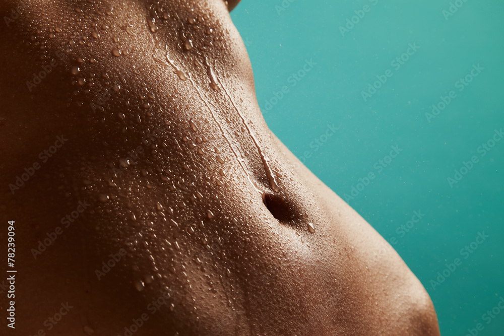 Fototapeta premium Beautiful woman's body with drops of water