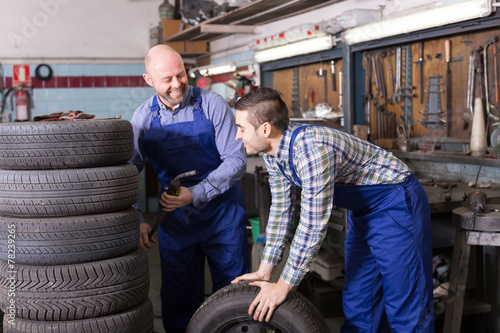 car mechanics  working at carshop photo