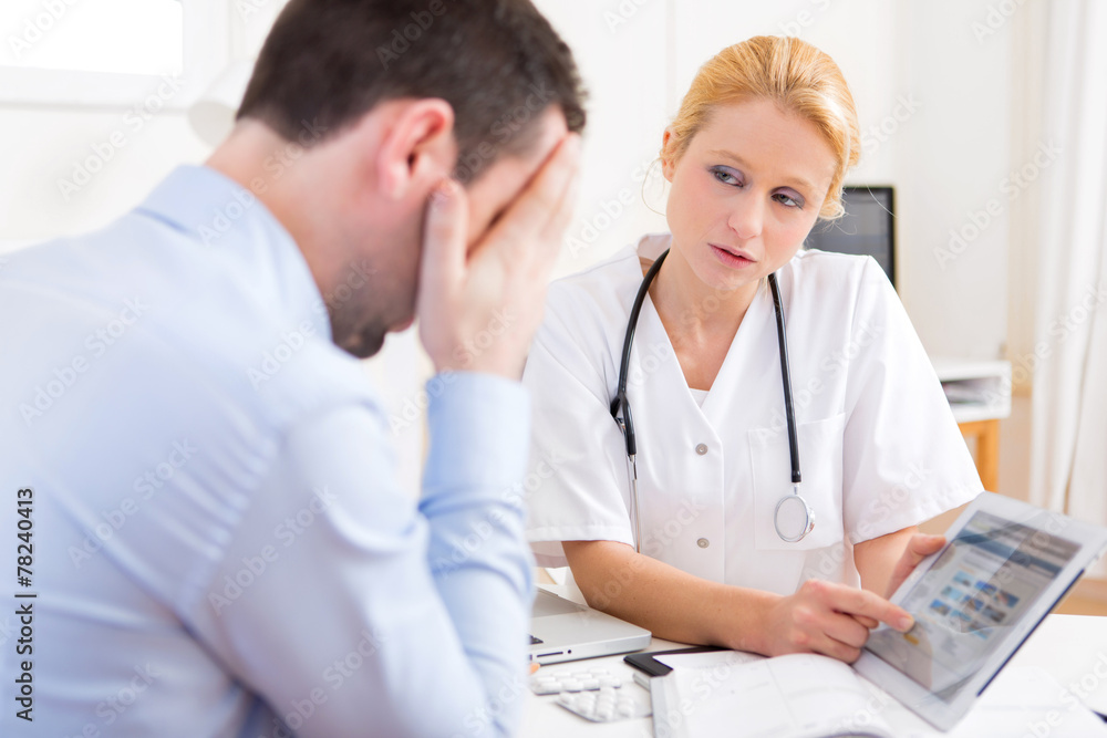 Young doctor showing results on tablet to patient Young doctor showing results on tablet to patient