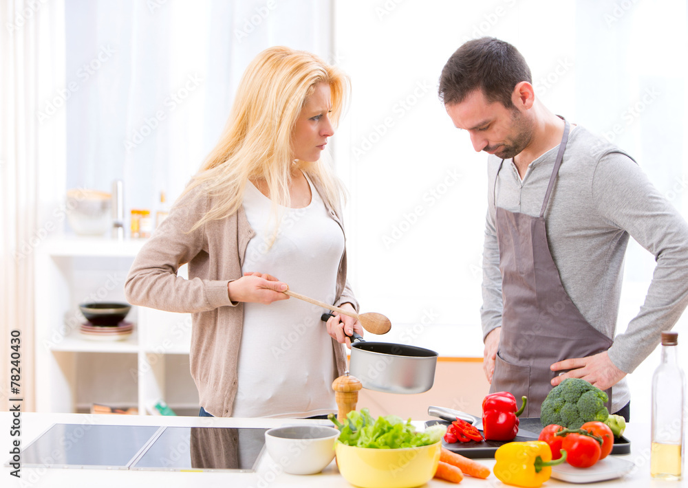 Young attractive couple having an argue while cooking Young attractive couple having an argue while cooking