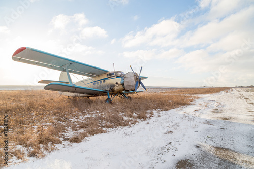 Fototapeta Naklejka Na Ścianę i Meble -  Old corn field biplane in winter