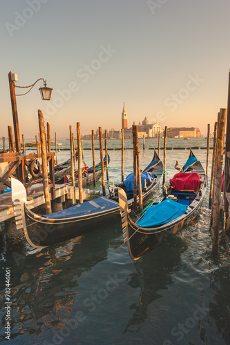 Gondolas docked to the poles on the Grand Canal in Venice.