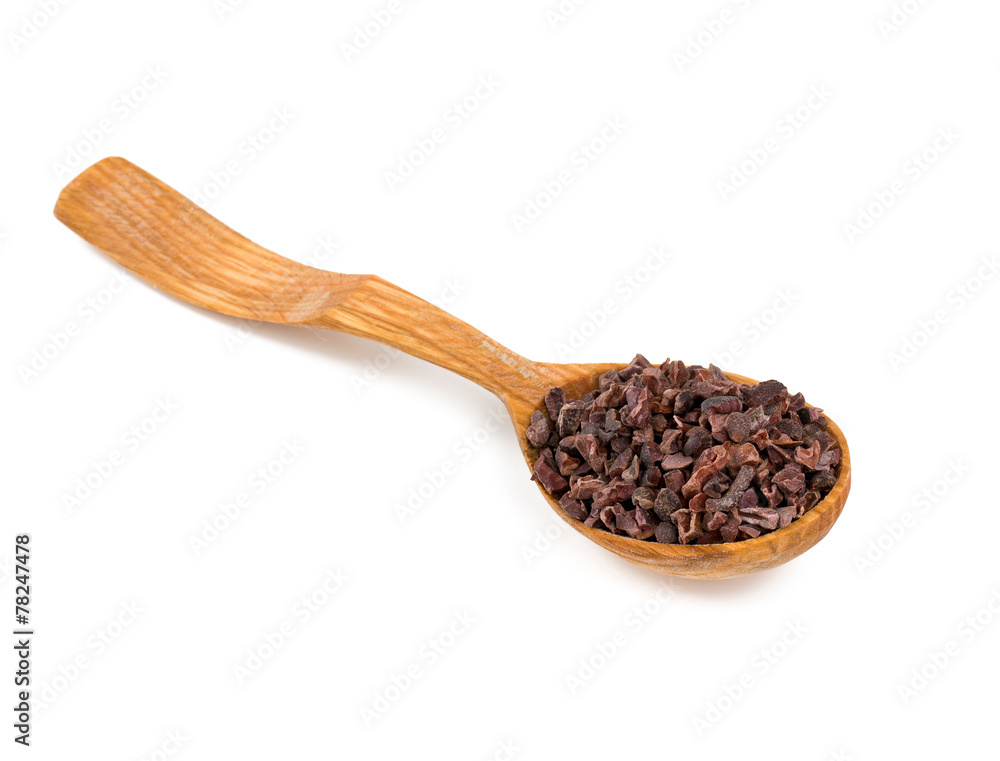 cocoa nibs in a wooden spoon cocoa nibs in a wooden spoon