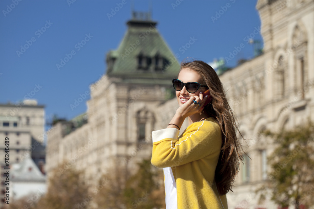 Fototapeta premium Happy young woman calling by phone