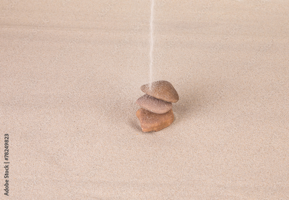 Sandy stream flows on a stack of stones. Sandy stream flows on a stack of stones.