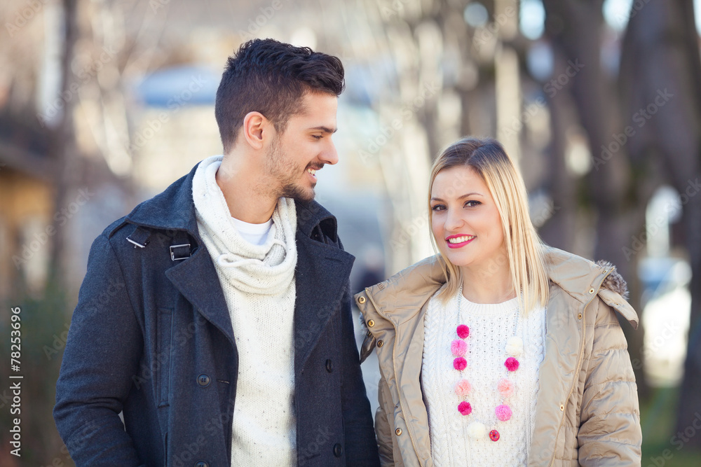 Fototapeta premium Portrait of happy young couple on the street