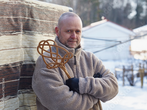 Man and carpet beater photo