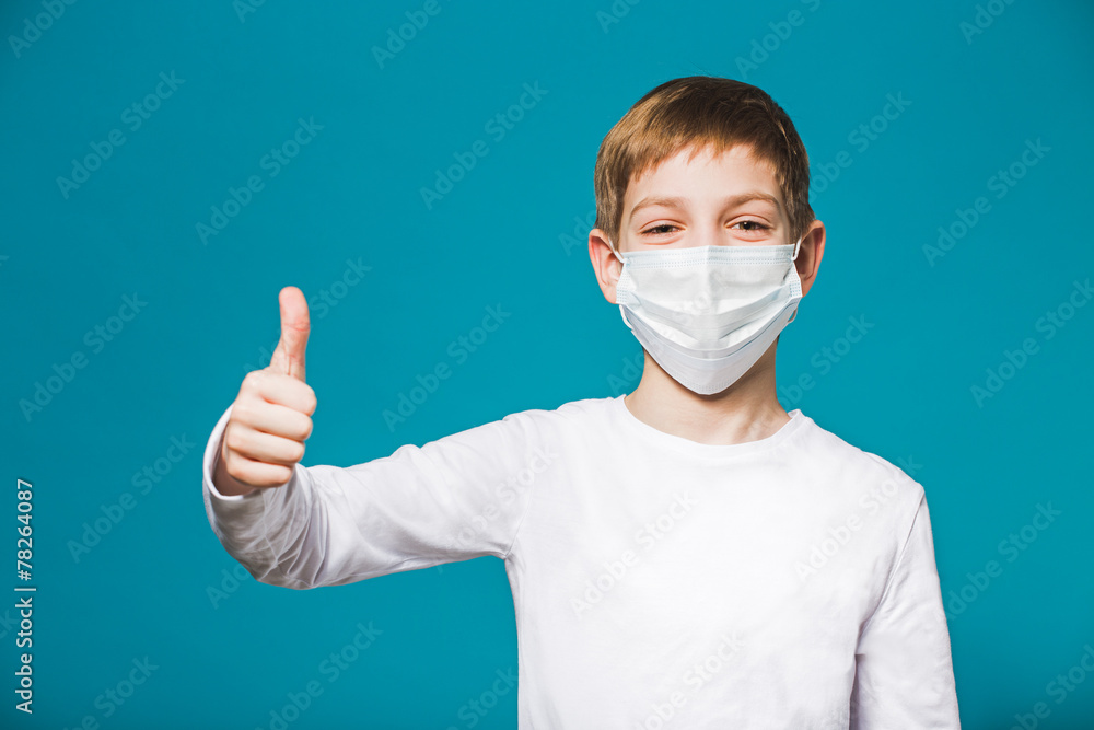 Boy showing thumb up in protection mask Boy showing thumb up in protection mask