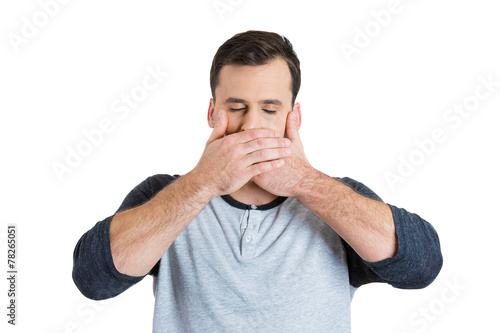 Φωτογραφία Man covers his mouth with hand isolated on white background