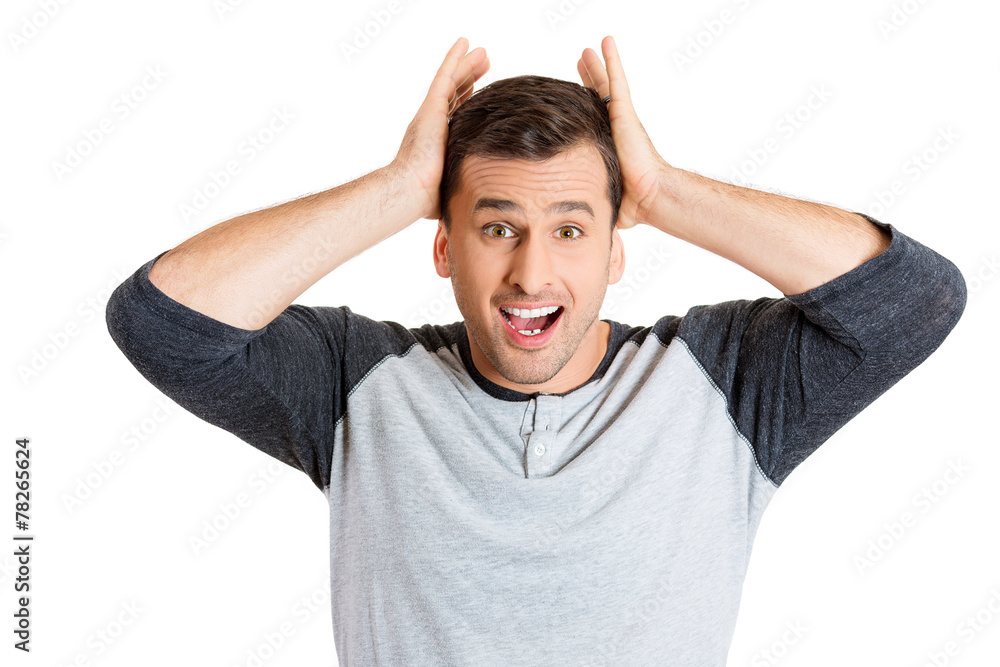 Smiling young man with surprised expression Smiling young man with surprised expression
