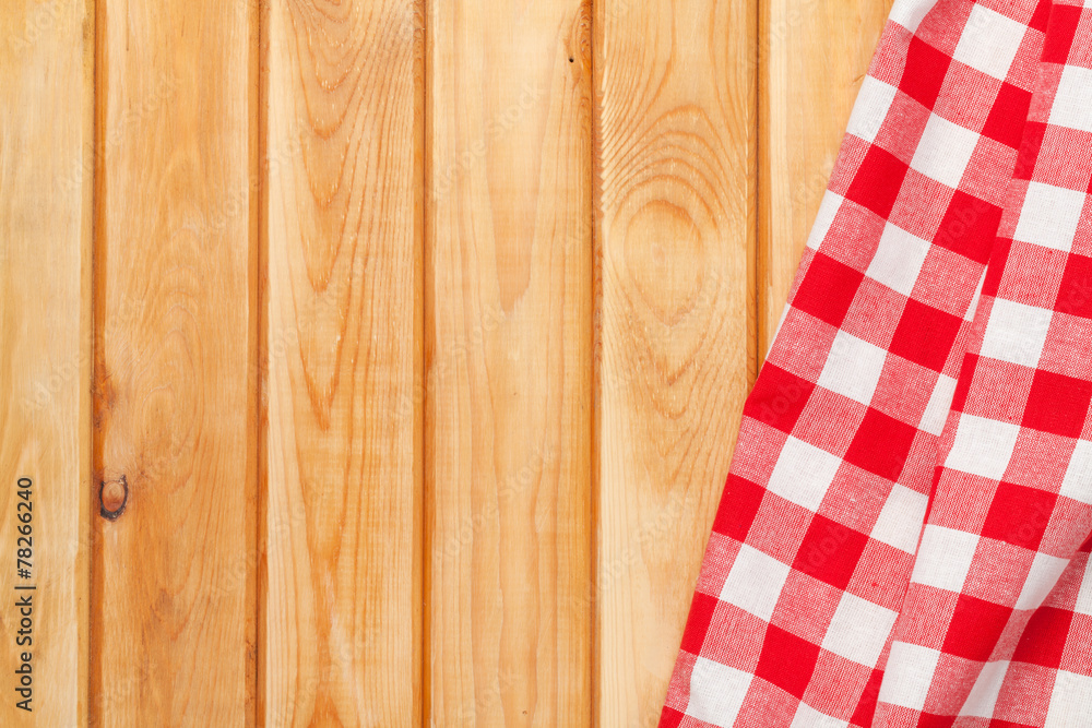 Red towel over wooden kitchen table Red towel over wooden kitchen table
