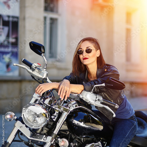 Biker girl in a leather jacket on a motorcycle © arthurhidden