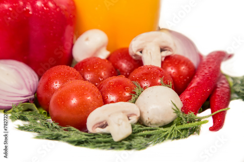 Vegetables lie on a lettuce leaf on a white background photo