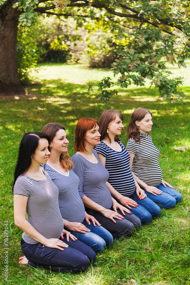Group of young pregnant women wearing the same clothes and Group of young pregnant women wearing the same clothes and