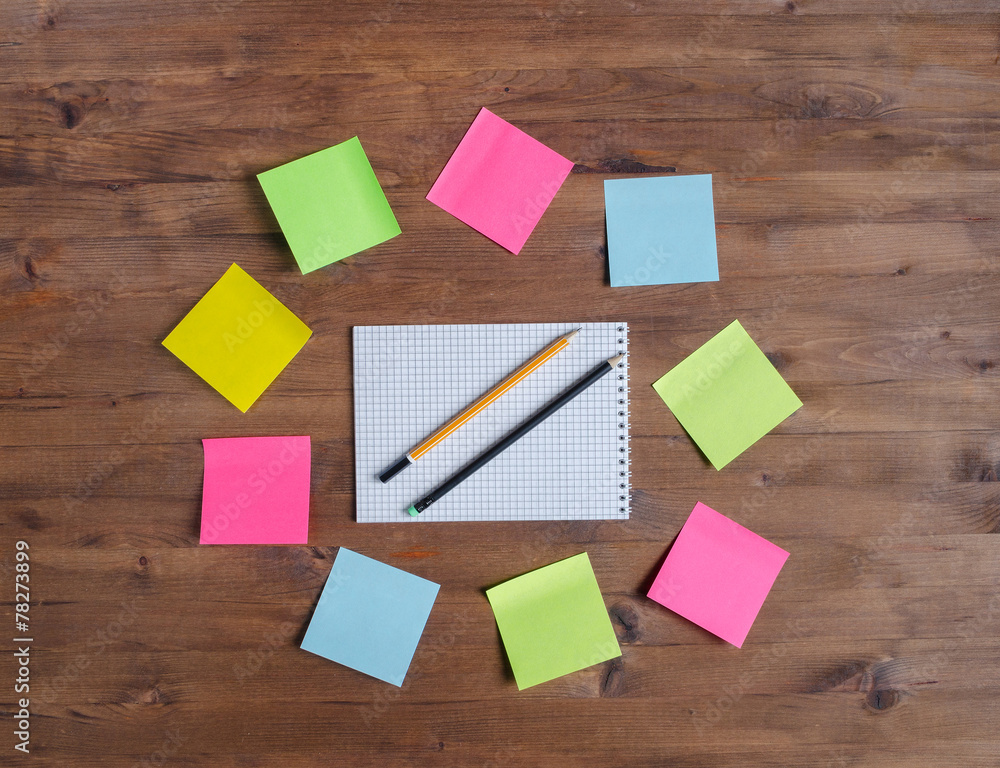colored stickers around notebook on table colored stickers around notebook on table
