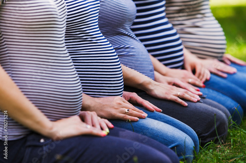 Closeup of group pregnant bellies. Pregnant women wearing the